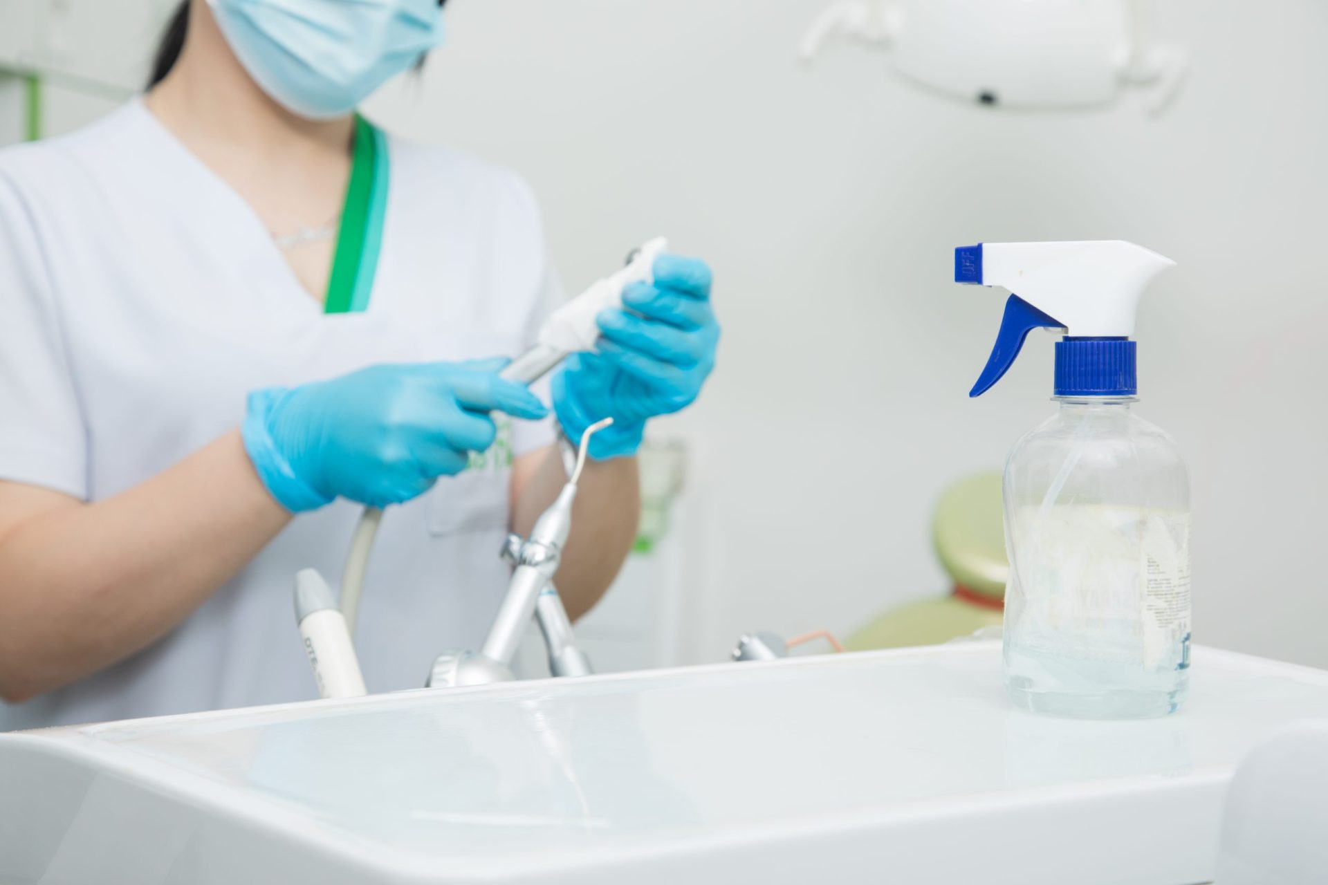 assistant cleans dentist tools